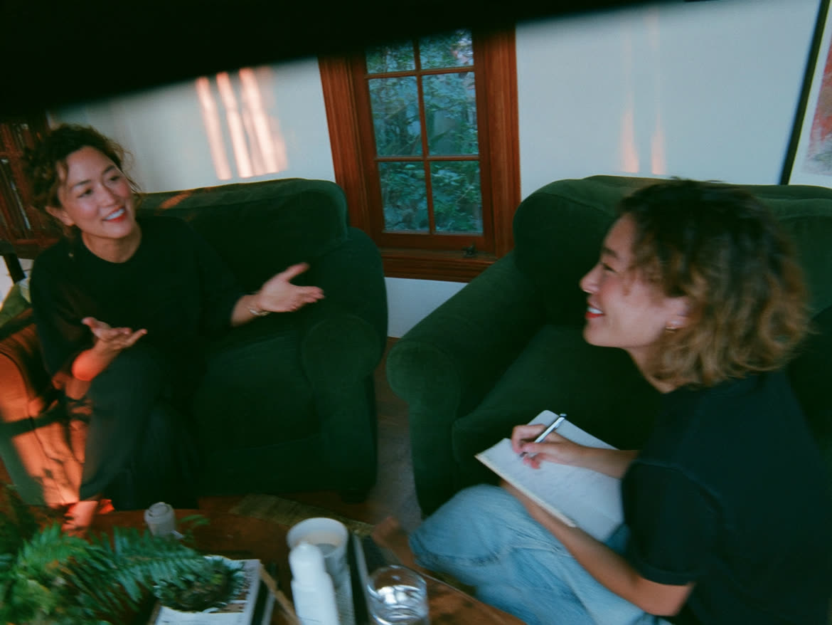 Coach and client talking in armchairs by a window
