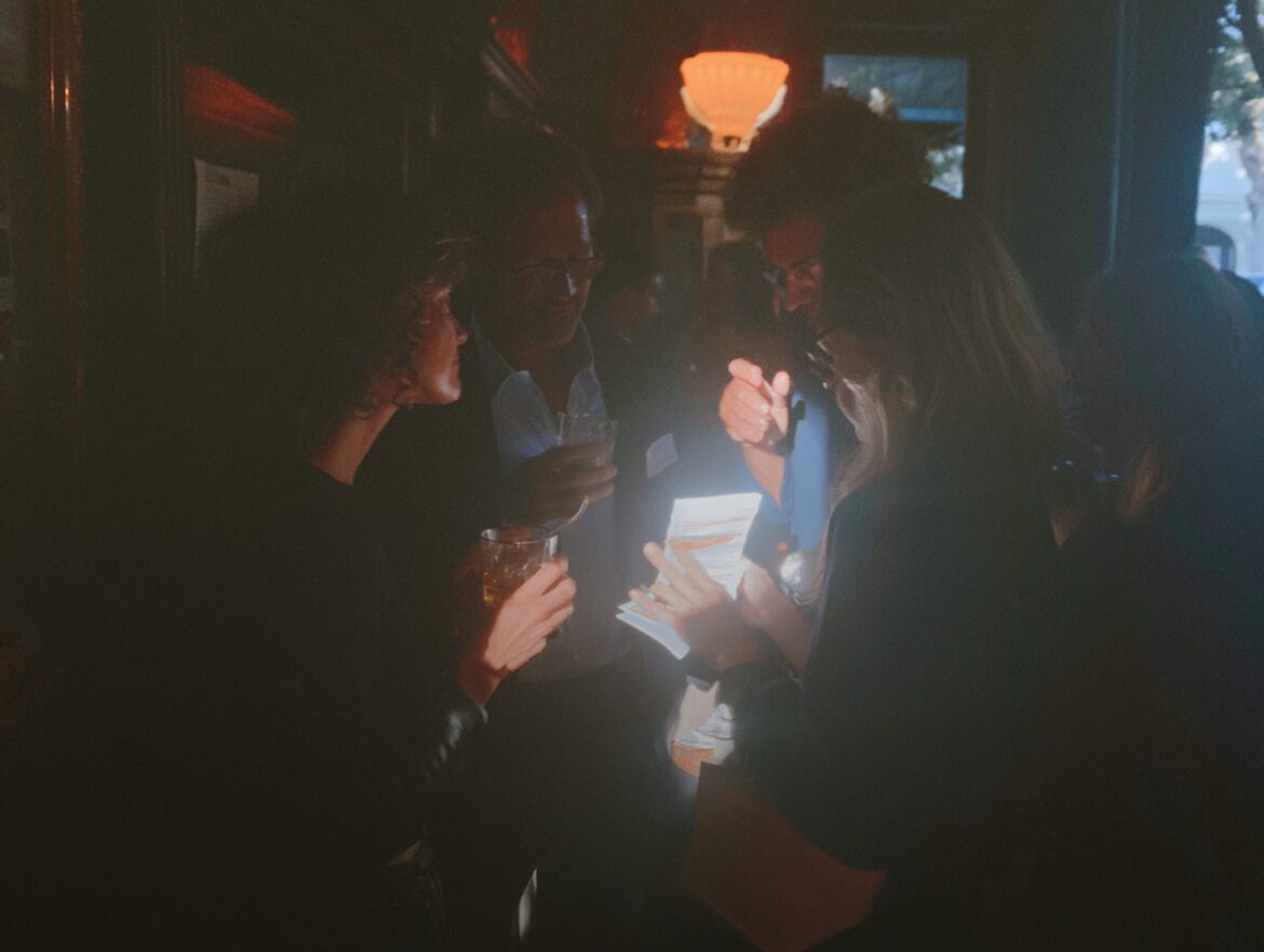 Friends gathered together outdoors at sunset